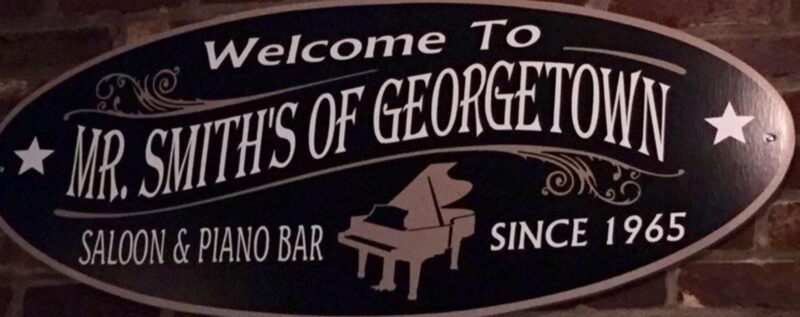 A sign that says Welcome to Mr. Smiths of Georgetown Saloon and Piano bar since 1965